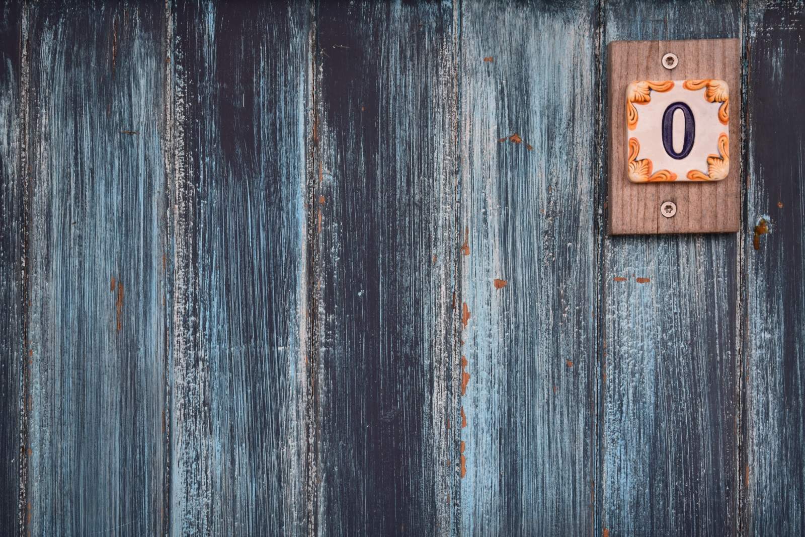 blue fence with wooden zero sign