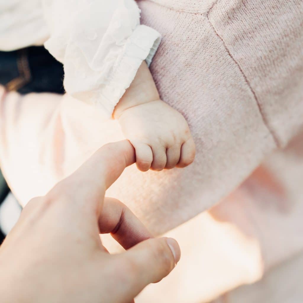 baby hand and mother in pink