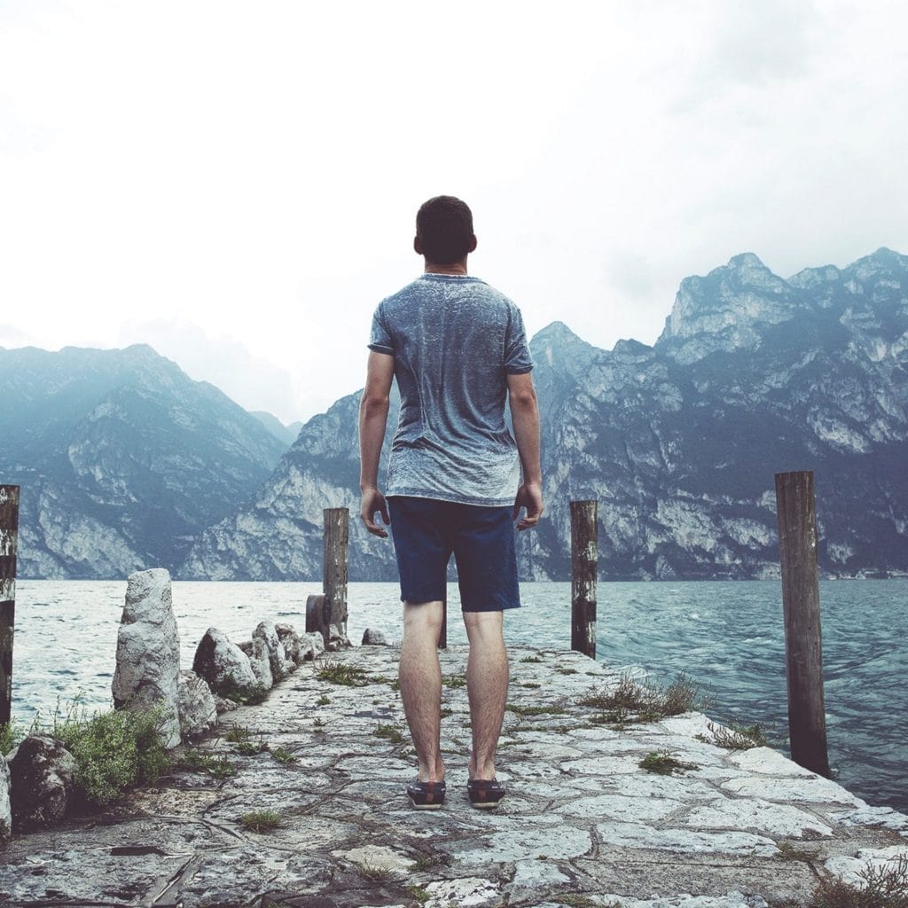 man standing on stony path