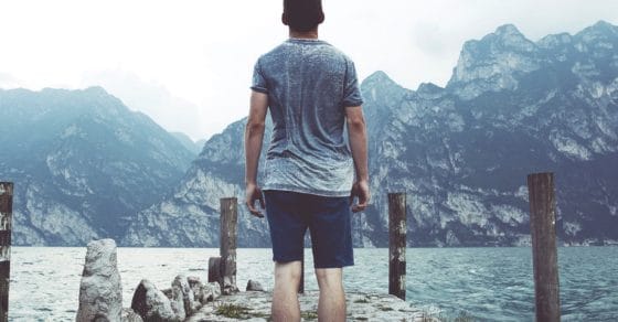 man standing on stony path