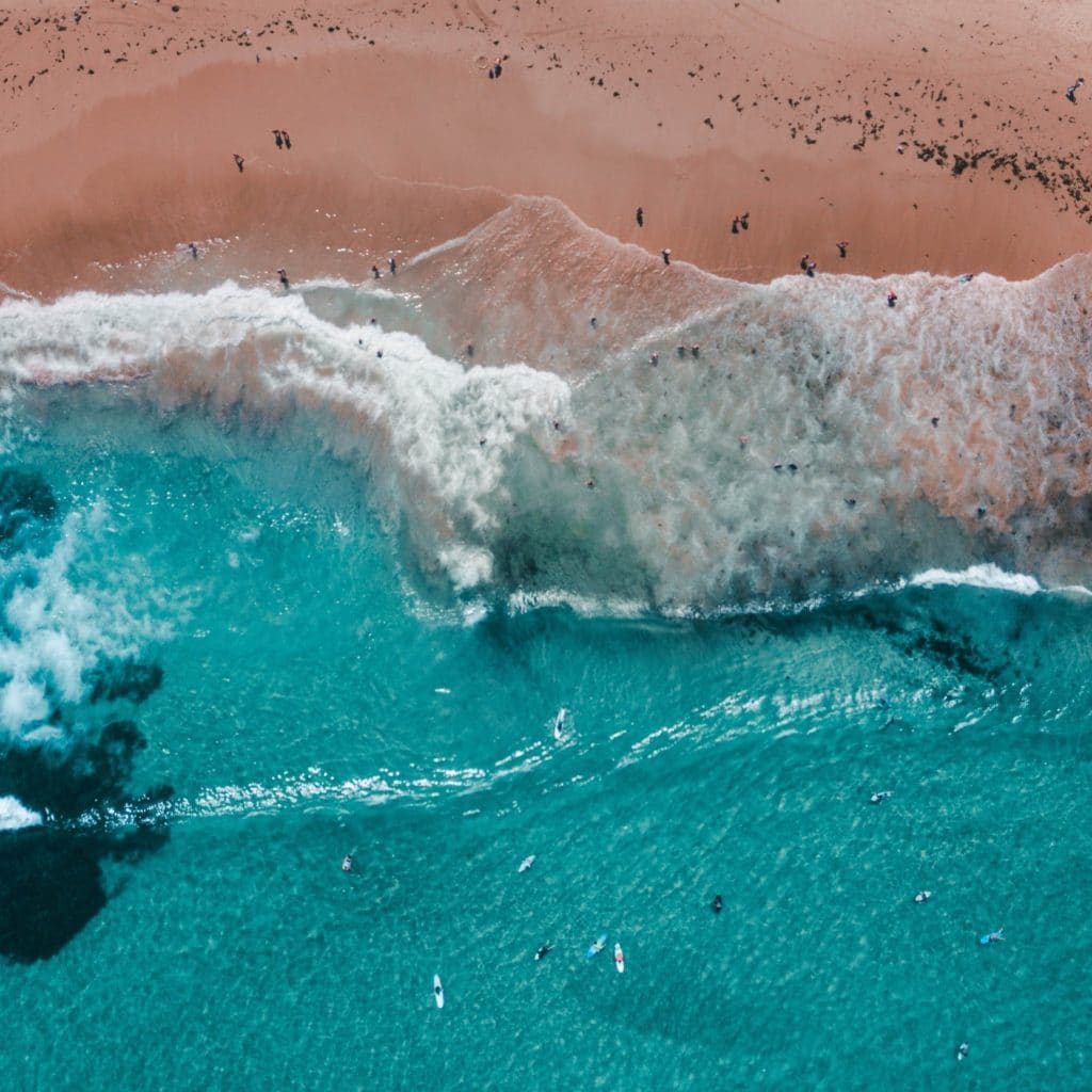 aqua blue sea and sandy beach shoreline topview