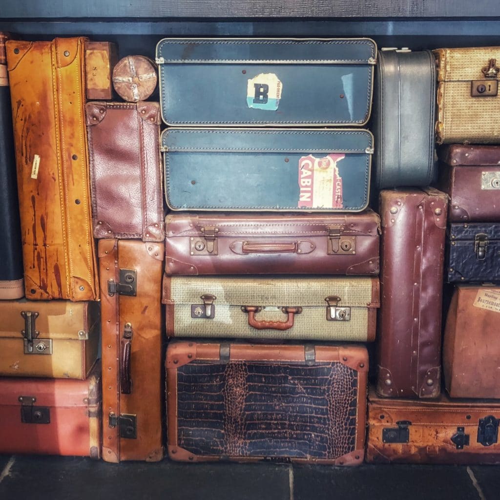 colorful suitcases stacked up high