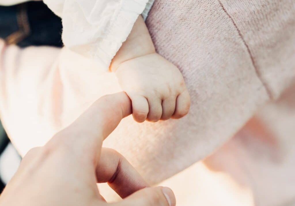 baby hand and mother in pink