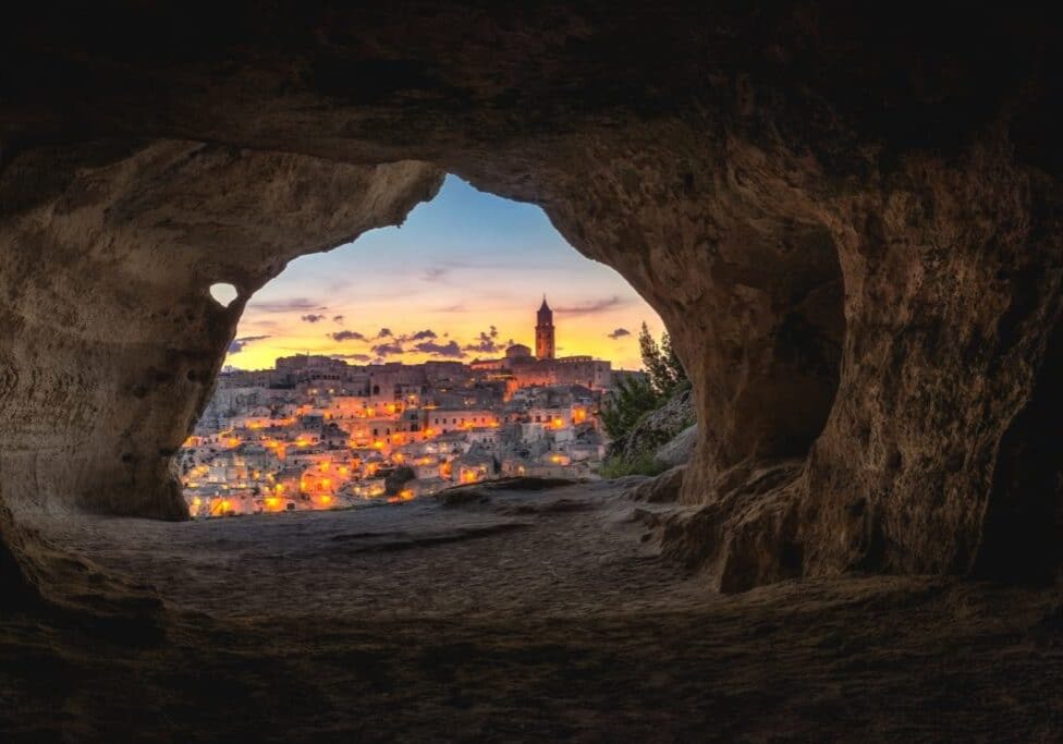 town illuminated through a cave opening